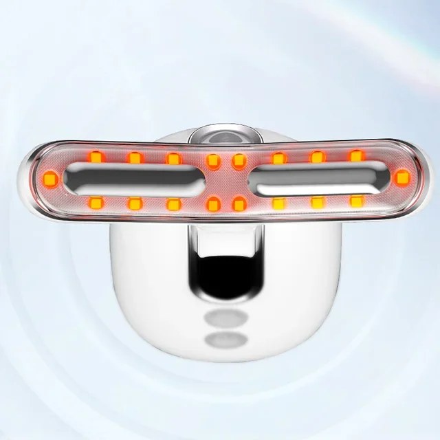 A sleek silver LED light therapy device glows with bright orange diodes against a soft blue background.